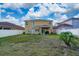 Spacious backyard featuring a white fence, well-maintained lawn, and a covered patio perfect for outdoor entertaining at 10937 Prairie Hawk Dr, Orlando, FL 32837