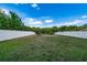 Large backyard with a privacy fence and green grass, great for outdoor activities at 10937 Prairie Hawk Dr, Orlando, FL 32837