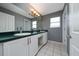 Bathroom features dual sinks, white cabinets, modern fixtures, and tile flooring at 10937 Prairie Hawk Dr, Orlando, FL 32837