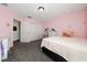 Pink bedroom with closet, carpet, and a single bed at 10937 Prairie Hawk Dr, Orlando, FL 32837