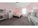 Bedroom features carpet, a window with white curtains, and simple decor at 10937 Prairie Hawk Dr, Orlando, FL 32837