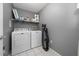 Laundry room includes a washer, dryer, shelving, and ample storage space at 10937 Prairie Hawk Dr, Orlando, FL 32837