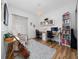 Bright living room with hardwood floors, guitar, stylish furniture, and a workspace at 10937 Prairie Hawk Dr, Orlando, FL 32837