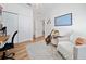 Cozy living room with a guitar, soft chair, hardwood floors, and natural light at 10937 Prairie Hawk Dr, Orlando, FL 32837