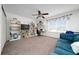 Spacious living room features built-in bookshelves, ceiling fan and comfortable seating at 10937 Prairie Hawk Dr, Orlando, FL 32837