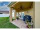 Outdoor patio features a ceiling fan, grill, and sliding door to the home's interior at 10937 Prairie Hawk Dr, Orlando, FL 32837
