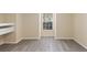 Bedroom featuring wood-look flooring, neutral walls, a window, and a built-in shelf at 1127 Anne Elisa Cir, St Cloud, FL 34772