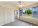 Bedroom featuring wood-look flooring, a ceiling fan, and large windows at 1127 Anne Elisa Cir, St Cloud, FL 34772