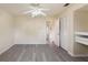 Bright bedroom with wood-look floors, ceiling fan, closet, and ensuite entrance at 1127 Anne Elisa Cir, St Cloud, FL 34772