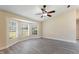 Living room with a bay window, ceiling fan, baseboards, neutral walls and wood-look flooring at 1127 Anne Elisa Cir, St Cloud, FL 34772