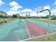 View of a basketball court featuring hoops and colorful court markings for community recreation at 12450 Greco Dr, Orlando, FL 32824