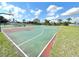 Community basketball court on a sunny day with blue sky and fluffy white clouds at 12450 Greco Dr, Orlando, FL 32824