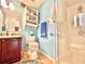 Bathroom featuring an open cabinet for storage and a glass shower stall at 12450 Greco Dr, Orlando, FL 32824