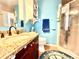 Well-lit bathroom featuring a vanity with granite countertop, shower and nautical themed decor at 12450 Greco Dr, Orlando, FL 32824