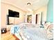 Bright bedroom featuring a TV, closet, and beach-themed comforter at 12450 Greco Dr, Orlando, FL 32824