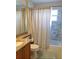 This bathroom features a granite countertop, a white toilet, and a shower and tub combo behind a shower curtain at 152 Moscato Dr, Davenport, FL 33897