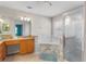 Bright bathroom featuring a soaking tub with marble tile surround and a glass-enclosed shower at 152 Moscato Dr, Davenport, FL 33897