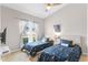 Bright bedroom with twin beds, outer space themed comforters, and a vaulted ceiling at 152 Moscato Dr, Davenport, FL 33897