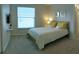 Comfortable bedroom featuring a large window, plush carpeting, and stylish decor at 152 Moscato Dr, Davenport, FL 33897