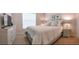 Serene bedroom featuring a large bed, dresser, and stylish decor at 152 Moscato Dr, Davenport, FL 33897