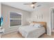 Cozy bedroom with neutral decor, a ceiling fan, and a window with blinds at 152 Moscato Dr, Davenport, FL 33897