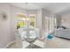 Bright breakfast nook with a glass table and backyard views near the pool at 152 Moscato Dr, Davenport, FL 33897