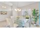 Elegant dining room with a glass table, seating for six, and a large bright window at 152 Moscato Dr, Davenport, FL 33897