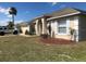 Beautiful home exterior featuring a lush green lawn and freshly mulched landscaping around the foundation at 152 Moscato Dr, Davenport, FL 33897