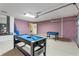 Garage game room with a pool table, foosball, and access to the laundry room at 152 Moscato Dr, Davenport, FL 33897