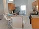 Open kitchen with granite counters, stainless steel appliances, and views of the adjacent dining area at 152 Moscato Dr, Davenport, FL 33897