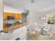 Eat-in kitchen showcasing a breakfast bar with granite countertops and modern appliances at 152 Moscato Dr, Davenport, FL 33897