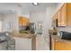 Open concept kitchen with breakfast bar and views to the breakfast nook and living area at 152 Moscato Dr, Davenport, FL 33897