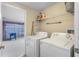 Laundry room with modern washer and dryer connections leading to the game room at 152 Moscato Dr, Davenport, FL 33897