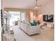 Bright living room featuring a sectional sofa, entertainment center, and sliding glass doors to the lanai at 152 Moscato Dr, Davenport, FL 33897