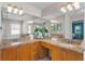 Main bathroom with double sinks, granite countertops, and a large decorative mirror at 152 Moscato Dr, Davenport, FL 33897