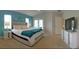 Bright main bedroom with a calming teal accent wall and large windows for natural light at 152 Moscato Dr, Davenport, FL 33897
