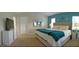 Spacious main bedroom with teal accents, a dresser, and a large comfortable bed at 152 Moscato Dr, Davenport, FL 33897