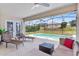 Cozy screened-in patio with lounge seating, overlooking the private swimming pool area at 152 Moscato Dr, Davenport, FL 33897