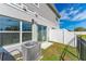 View of the home's back patio, showing the sliding glass doors, A/C unit, and fenced backyard at 1536 Mirabella Cir, Davenport, FL 33897