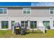 Spacious backyard showing a well-manicured lawn, rear home facade, and trash bins at 1536 Mirabella Cir, Davenport, FL 33897