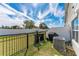 Fenced backyard features a grassy lawn and an A/C unit to keep you cool in the Florida heat at 1536 Mirabella Cir, Davenport, FL 33897
