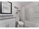 Bathroom with framed mirror, granite countertop vanity, and a tub with a shower and shower curtain at 1536 Mirabella Cir, Davenport, FL 33897