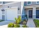 Exterior close-up showcasing landscaped entryway to home's front door and garage at 1536 Mirabella Cir, Davenport, FL 33897