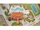 An aerial view of a clubhouse featuring a pool, tennis courts, and a playground at 1787 Coriander Dr, Kissimmee, FL 34759