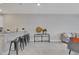 Spacious living room featuring an open layout, breakfast bar seating, and stylish decorative elements at 1787 Coriander Dr, Kissimmee, FL 34759