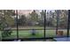 Backyard view of manicured lawn, native plants, and screened enclosure at 17880 Passionflower Cir, Clermont, FL 34714