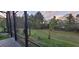Screened-in patio with view of spacious backyard featuring lush greenery at 17880 Passionflower Cir, Clermont, FL 34714
