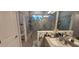 Modern bathroom with a large glass-enclosed shower, stylish vanity, and contemporary fixtures at 17880 Passionflower Cir, Clermont, FL 34714