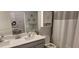 Bright bathroom with double sink vanity, neutral color scheme, and ample storage space at 17880 Passionflower Cir, Clermont, FL 34714