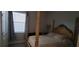 Bedroom featuring an elegant bed frame and soft natural light coming through the window at 17880 Passionflower Cir, Clermont, FL 34714